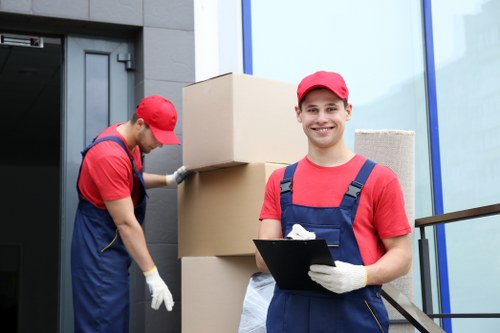 Movers carrying furniture from a Surrey home
