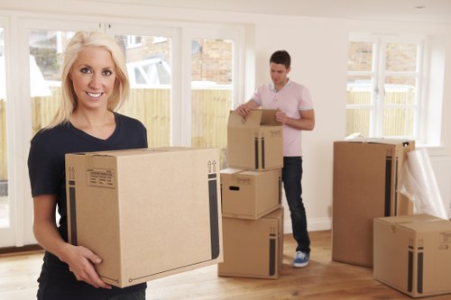 Local moving team handling boxes and furniture in Surrey