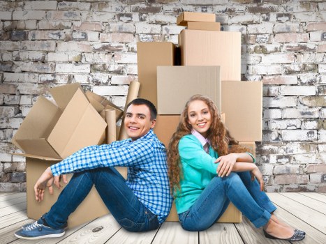 Removalists unloading household items at a new Surrey home