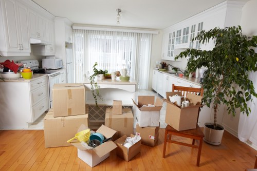 Labelled office boxes and furniture ready for a commercial move in Surrey