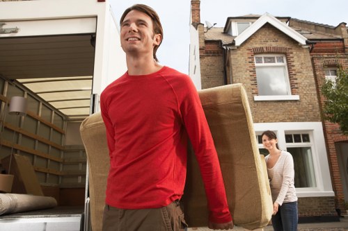 Prepared moving boxes and furniture ready for man with van removal in Surrey