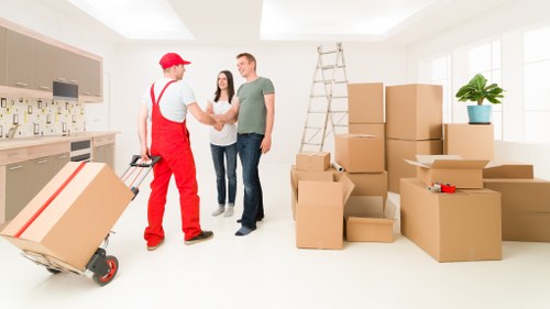 A worker assessing moving risks and preparing equipment for a van service