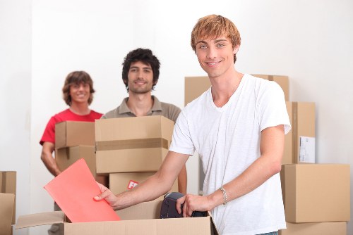Protected movers carrying furniture carefully at a property