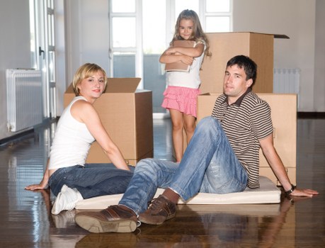 Professional movers carrying furniture during a local house move